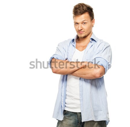 Stylish man in blue shirt and jeans with earring isolated on white Stock photo © Nejron