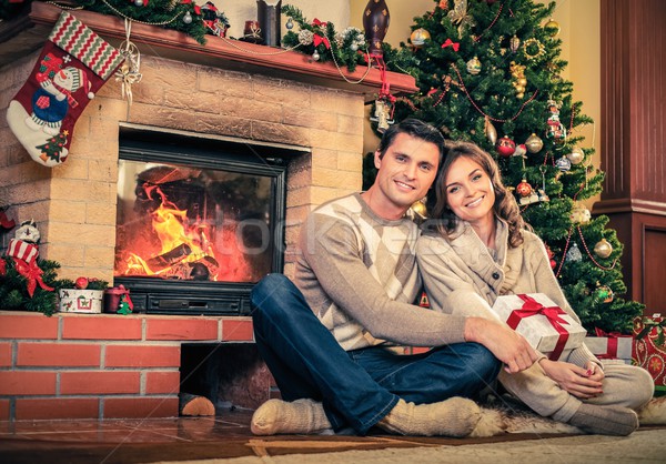 Casal lareira natal decorado casa interior mulher Foto stock © Nejron