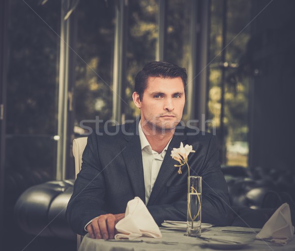 Handsome man in jacket waiting someone in restaurant  Stock photo © Nejron