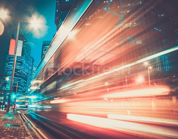 Fast moving cars at night in modern city Stock photo © Nejron