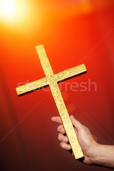 Golden cross in human hand Stock photo © Nejron