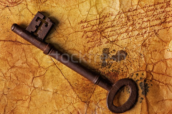 The old key on the textured paper Stock photo © Nejron