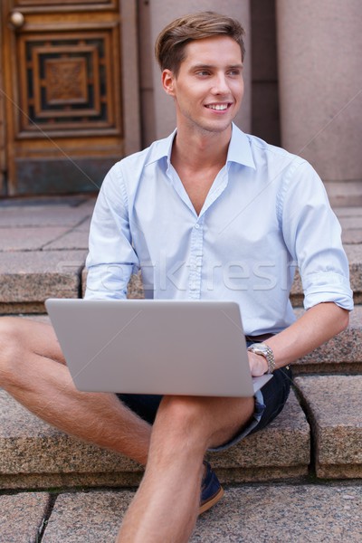 Gut aussehend junger Mann Laptop Sitzung Schritte Freien Stock foto © Nejron