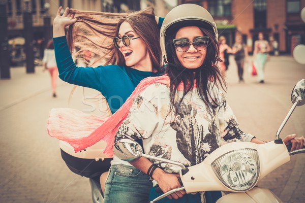 Többnemzetiségű lányok moped európai város lány Stock fotó © Nejron