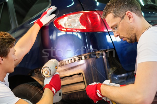 Two workers with colour samples choosing correct tone in a car body workshop  Stock photo © Nejron