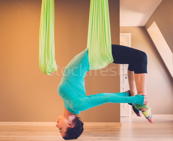 Young woman performing antigravity yoga exercise  Stock photo © Nejron