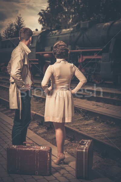 Beautiful vintage style couple with suitcases on  train station platform Stock photo © Nejron