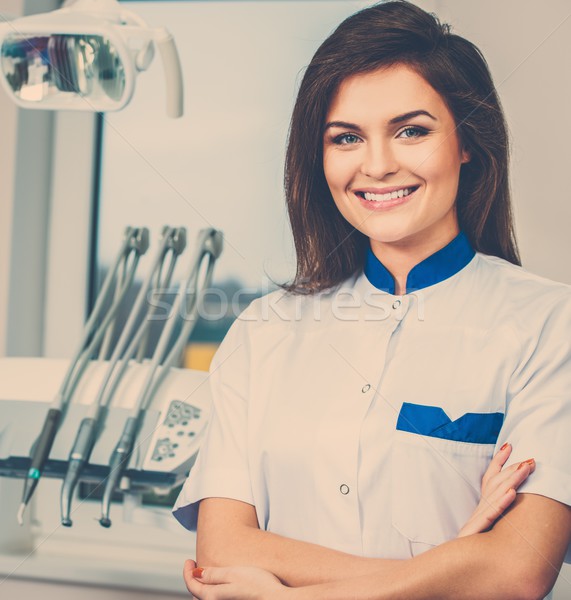 Young beautiful brunette female dentist at dentist's surgery  Stock photo © Nejron