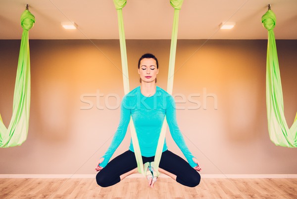 Young woman performing antigravity yoga exercise  Stock photo © Nejron