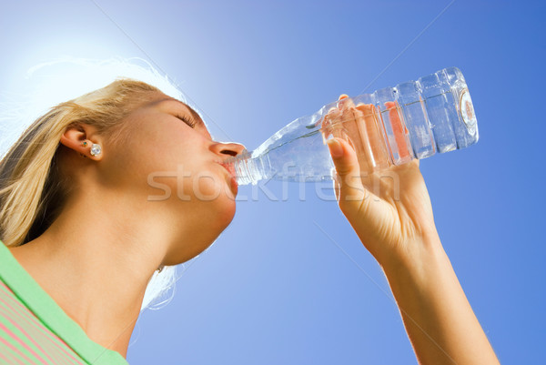 Beautiful blond girl drinking water Stock photo © Nejron