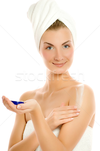 Young lovely woman applying moisturizer to her skin after shower Stock photo © Nejron