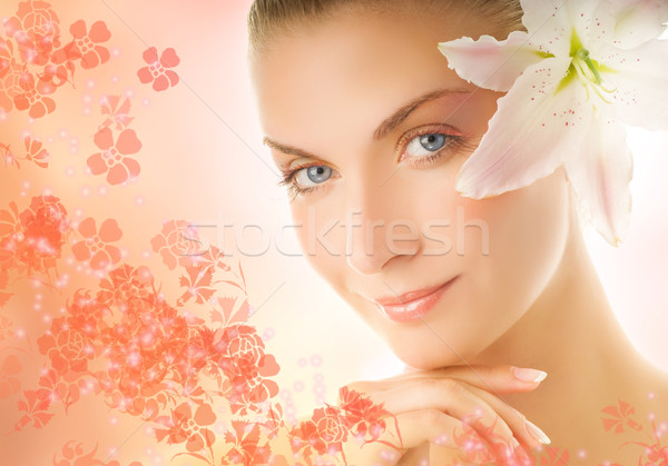 Beautiful young woman with lily flower ove abstract background Stock photo © Nejron