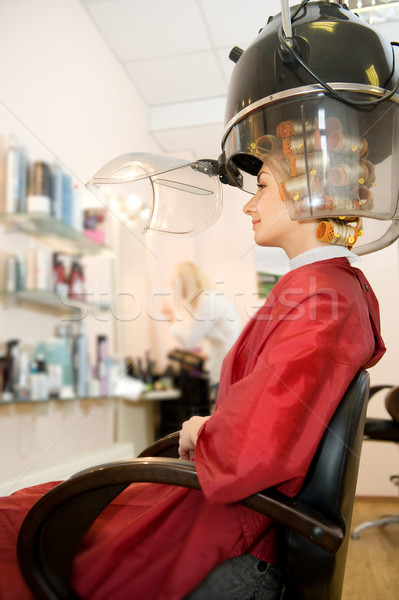 Young woman drying her hair in beauty salon Stock photo © Nejron