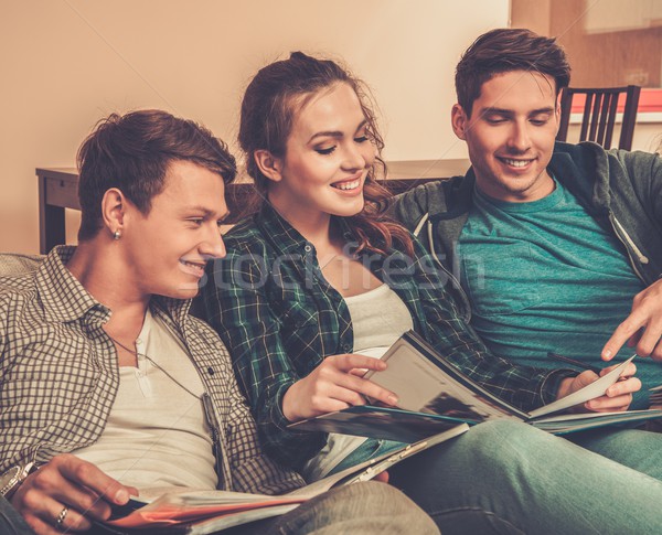 Three young students preparing for exams in apartment interior  Stock photo © Nejron