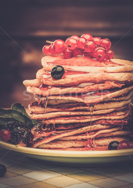 Tasty pancakes with maple syrup and fresh berries on a plate  Stock photo © Nejron