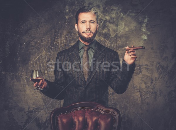 Handsome well-dressed with glass of beverage and cigar Stock photo © Nejron