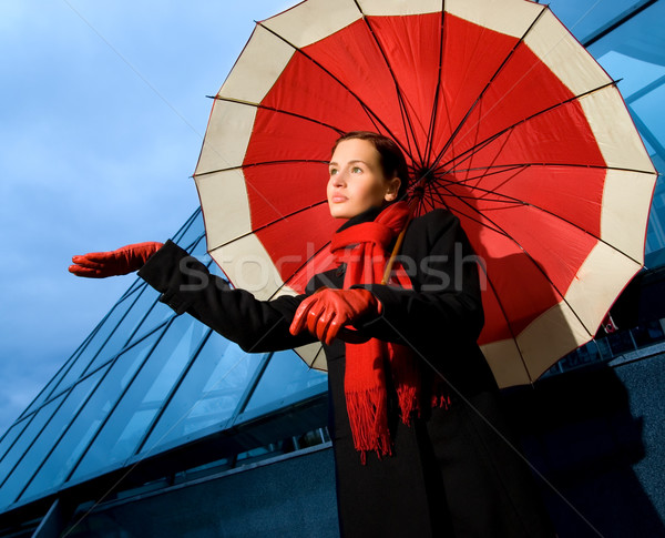 Beautiful young woman with red umbrella on rainy day Stock photo © Nejron