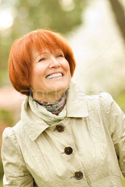 Beautiful smiling middle-aged woman outdoors Stock photo © Nejron