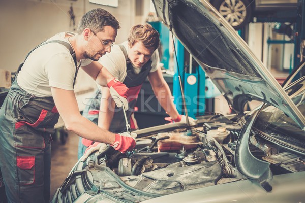 Two mechanics fixing car in a workshop Stock photo © Nejron