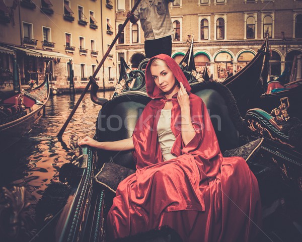 Beautiful woman in red cloak riding on gondola Stock photo © Nejron