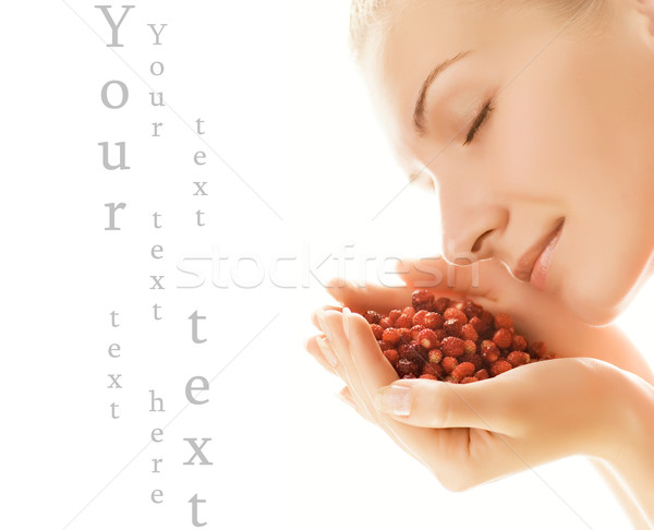 Stock photo: Beautiful young woman with handful of strawberries isolated on w