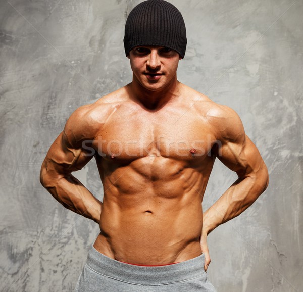 Handsome man with muscular torso in beanie hat posing  Stock photo © Nejron