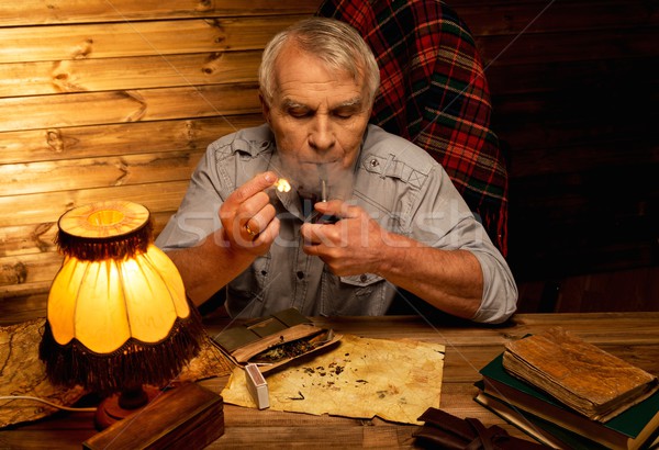 Senior man with smoking pipe in homely wooden interior  Stock photo © Nejron