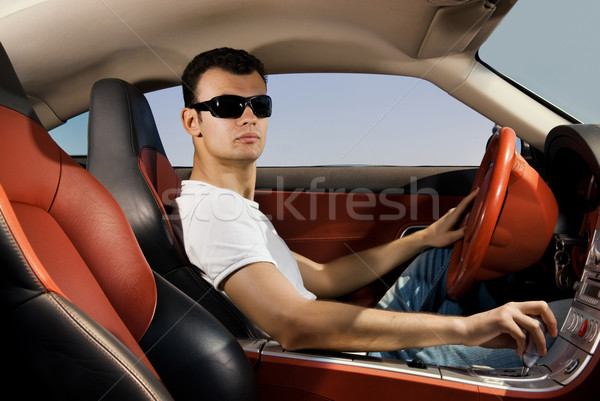 Handsome young man driving modern sport car Stock photo © Nejron