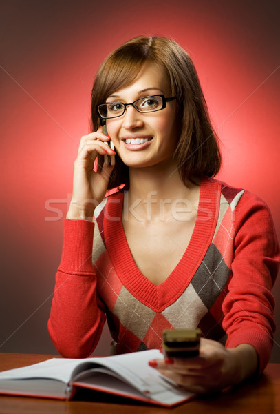 Beautiful redhead woman searching a phone number in telephone di Stock photo © Nejron