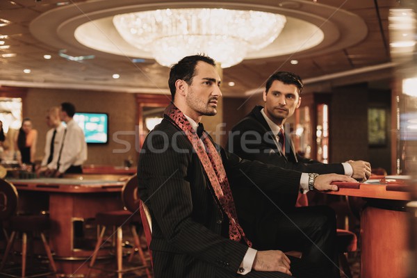 Two young men in suits behind table in a casino Stock photo © Nejron