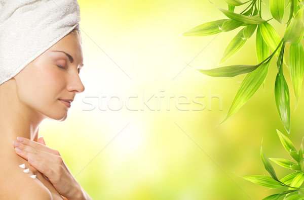 Beautiful young woman applying organic cosmetics to her skin Stock photo © Nejron