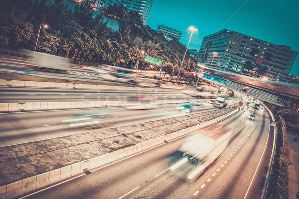 Fast moving cars at night in modern city Stock photo © Nejron