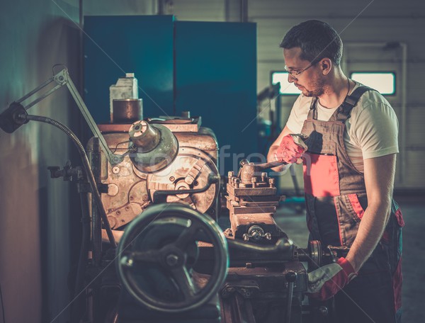 Serviceman working on lathe machine in car workshop Stock photo © Nejron