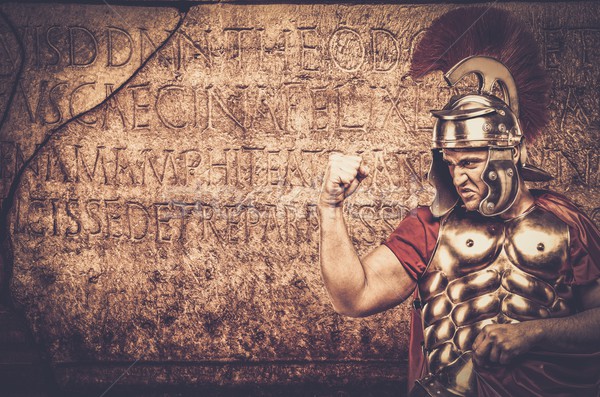 Roman legionary soldier in front of  wall with ancient writing  Stock photo © Nejron