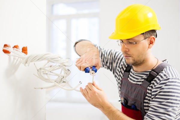 Stock photo: Electrician working with wires in new apartment 