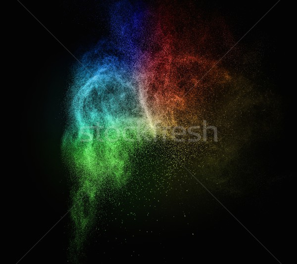 Stock photo: Colourful powder exploding isolated on black