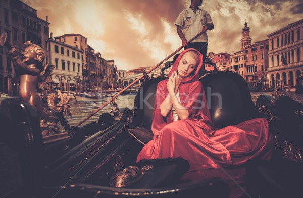 Piękna kobieta czerwony płaszcz jazda konna gondola wody Zdjęcia stock © Nejron