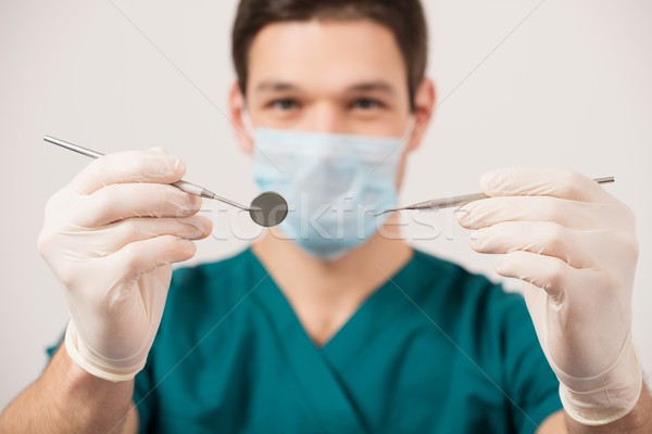 Young male dentist holding dental tools  Stock photo © Nejron