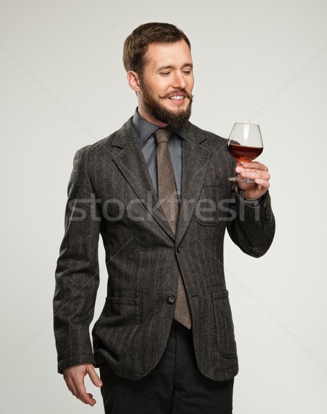 Handsome well-dressed man in jacket with glass of beverage Stock photo © Nejron