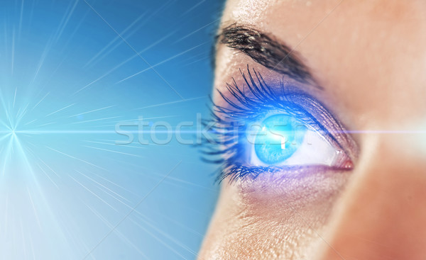 Stock photo: Eye on blue background (shallow DoF) 
