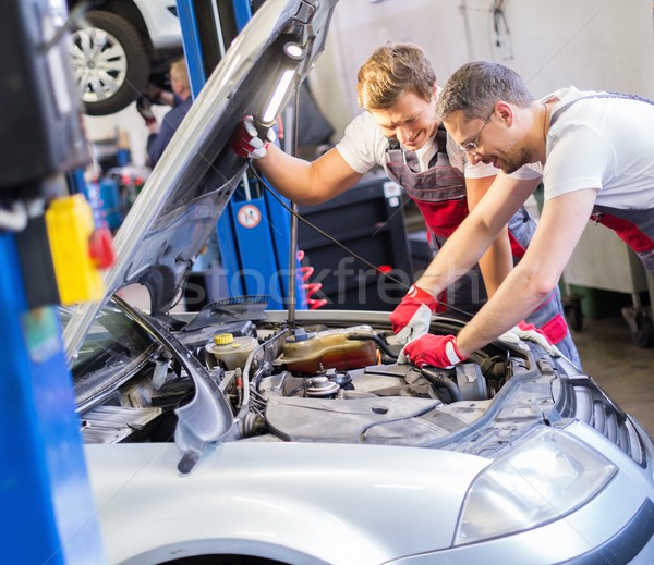 Two mechanics fixing car in a workshop Stock photo © Nejron
