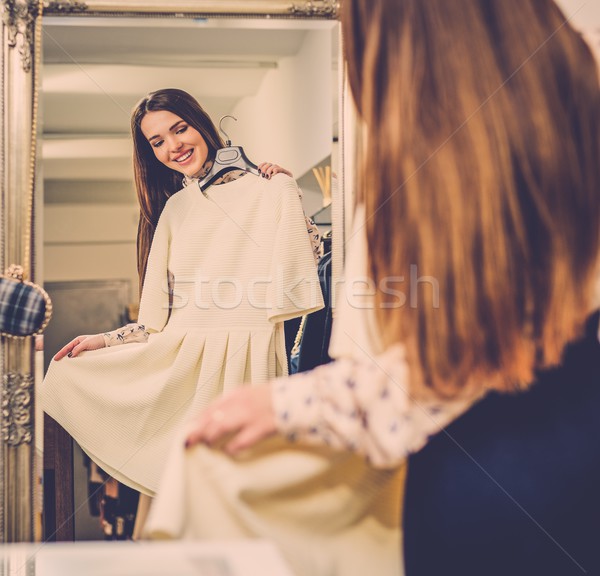 Young woman choosing clothes in a showroom  Stock photo © Nejron