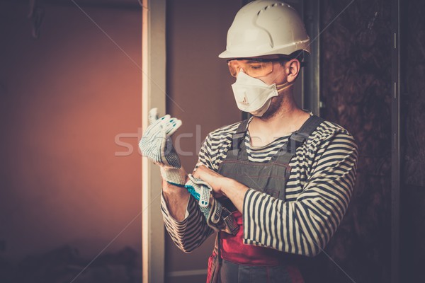 Builder in protective wear during new building construction  Stock photo © Nejron