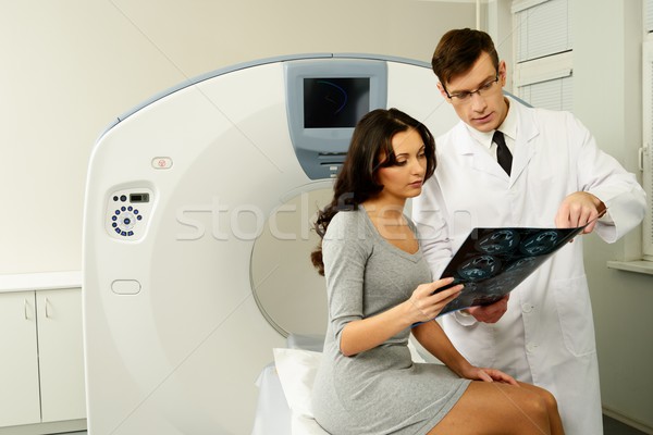 Doctor with young woman patient looking at the computed tomography results Stock photo © Nejron