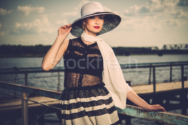 Woman in white hat and scarf standing near old pier rails  Stock photo © Nejron