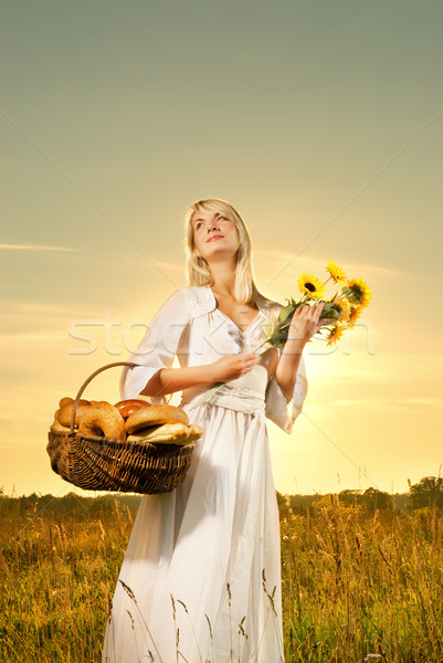 Beautiful young woman with a basket full of fresh baked bread Stock photo © Nejron