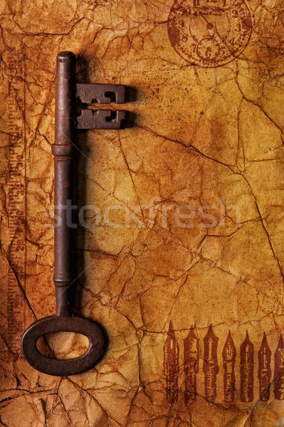 The old key on the textured paper Stock photo © Nejron