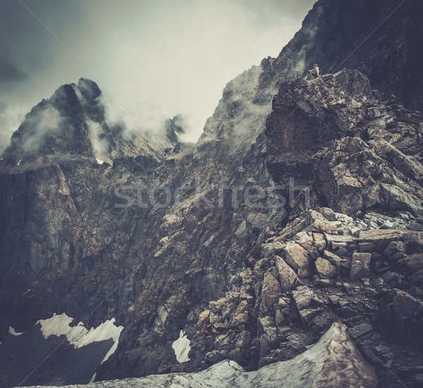 Woman hiker sitting on a mountain peak  Stock photo © Nejron