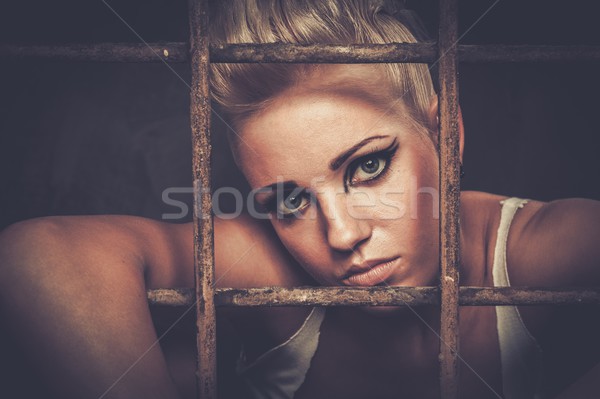 Troubled teenager girl behind bars Stock photo © Nejron