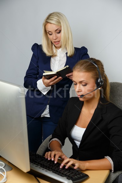 Beautiful help desk office support woman with female boss behind her Stock photo © Nejron